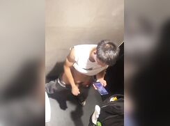 chinese boy making a mess in a stall
