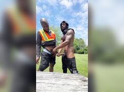 Two black guys jerking together in the park