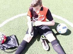 this soccer boy really takes care of his soccer boots