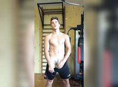 Gym muscle boy reveals cock, wanks and cums on table