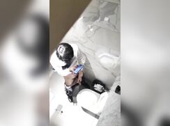 chinese man taking a quick break in toilet