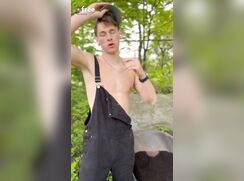 Cute country boy plays in the woods.