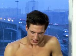 Uncut brunette cumming by the window