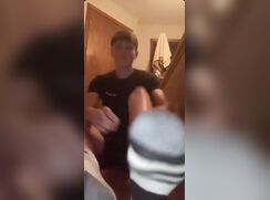 Teen shows off his feet in his bedroom