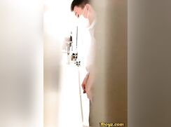 A male is pissing in the toilet 23