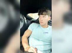 Cute college guy strokes his dick in the car