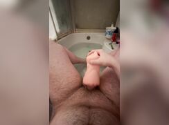 Hairy chub plays with a toy vagina