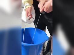Pissing in bucket in front of friends
