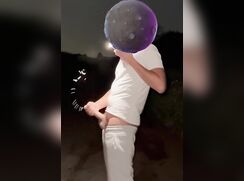 Face obscured boy in white cums outside