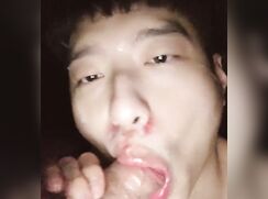Cute twink is sucking a big dick that explodes on his face.