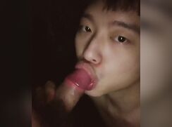 Cute twink is sucking a big dick that explodes on his face.