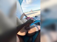 On the beach in a tent handjob