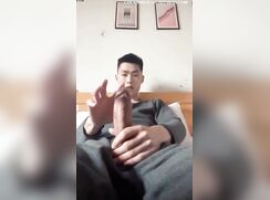 thick cocked asian grips his cock