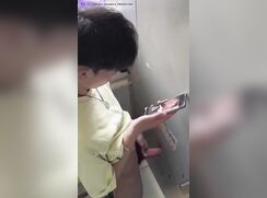 asian twink cums watching gay porn in bathroom