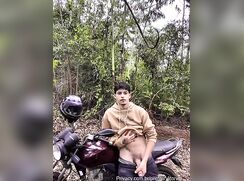 Motorcycle boy jerking off in the nature