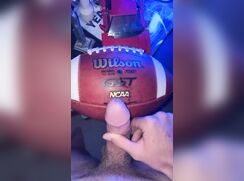 Athlete rubs precum on his football