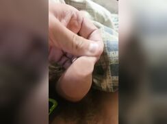 Uncut guy plays with coin in his foreskin