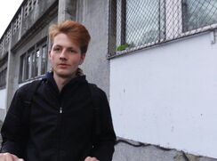 CH 576, Camera guy pays a young guy on an electric scooter wearing a black jacket  to