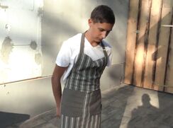 CH 700, Camera guy pays a young guy in a white T and a brown stiped apron, working at