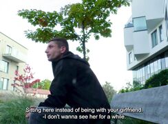 CH 722, Camera guy pays a young guy in a black hooded jacket, sitting on a bench to s