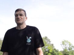 CH 766, Camera guy pays a young guy in a black bunny logo'd T and blue shorts, joggin
