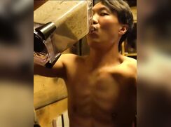An Asian boy is drinking a smoothie...
