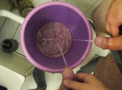 a good friend is helping me to fill my piss bucket and enjoys my pissing cock