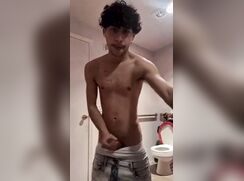 Horny Latino beating off in the bathroom