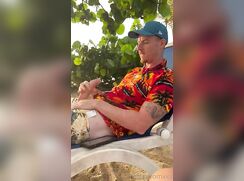 Wanking on the beach with the sun setting in the evening