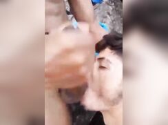 Sucking his cock hidden in the rocks