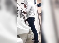 dude reveals a monstercok in public urinal