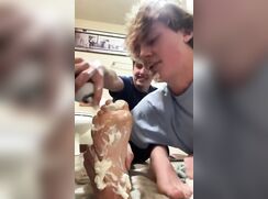 Licking cream off a guy's feet