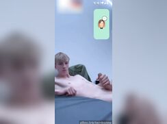 Skinny blond twink stroking his uncut dick for a show