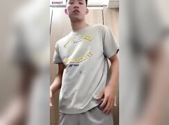 College jock stripping down and beating off in the locker room stall