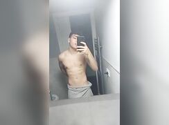 Selfie stroking his cock in the bathroom
