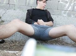 Big dicked twink jerks off outdoors