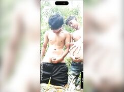 Two friends beat-off in the bushes