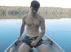 Naked in a gaytube boat on a lake