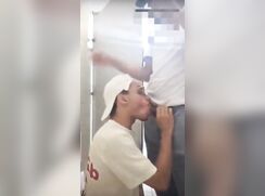 Sucking black cock in a public toilet stall