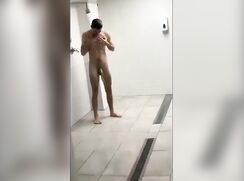 cute fit dude taking a shower at the gym